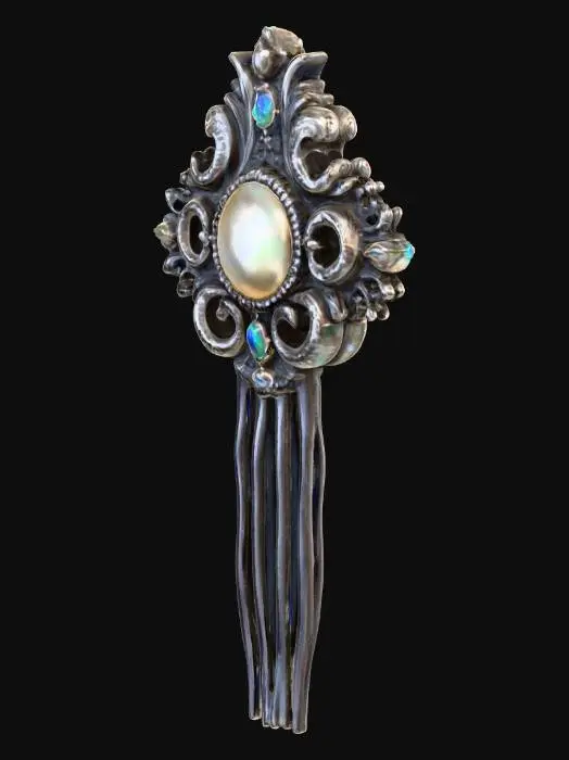 3D model for A Victorian-style hair pin, primarily crafted from polished sterling silver, features a central oval-shaped mother of pearl inlay with a subtly iridescent sheen. The silver frame is intricately sculpted with delicate filigree scrollwork, accented by tiny, bezel-set emeralds at each cardinal point and small, deep blue sapphires nestled within the curves of the design, giving it a luxurious, antique appeal.