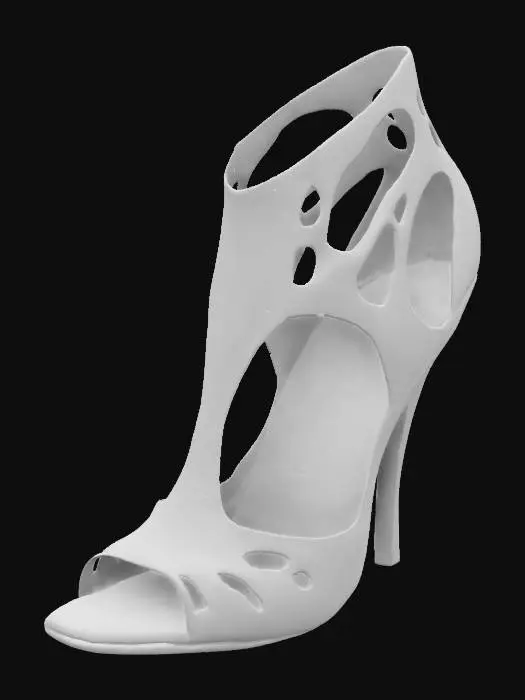 3D model for The object is a high-heeled shoe with an intricate, sculptural design featuring open cutouts and a combination of glossy black and orange leather texture.,
