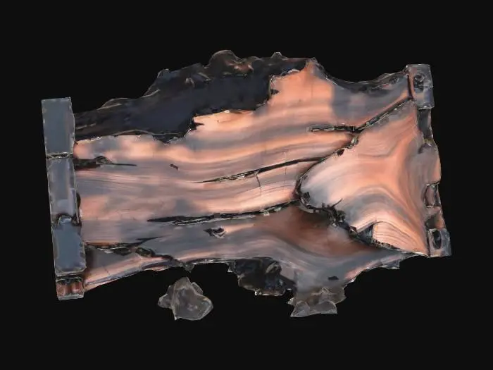 3D model for Burned and broken wooden furniture lies on its side, deeply charred and blackened from a fire. It is rendered with clean, angular geometry.