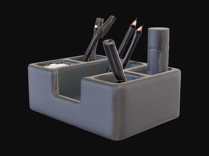 3D model for A sleek, rectangular desk organizer made from smooth, matte dark gray plastic. It features a robust, monolithic form with clean lines and subtly rounded edges. The top surface is segmented into various compartments: several tall, narrow cylindrical slots for pens and pencils, smaller rectangular depressions perfect for erasers and paper clips, and a specific, slightly wider rectangular slot designed to hold a vape device, ensuring a tidy and organized workspace.