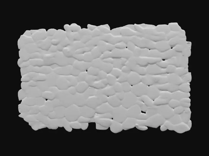 3D model for A low-profile pebble strip mesh, measuring 4x1x0.05 meters, is densely packed with numerous rounded pebbles, each ranging from 2 to 6 centimeters in diameter. The pebbles vary in natural colors from muted grays and sandy browns to hints of ochre and deeper terracotta, exhibiting smooth, water-worn textures. This continuous strip forms a uniform, flat surface, designed to interlock seamlessly with other sections for a repeating border. The overall structure feels firm and compact beneath the touch.