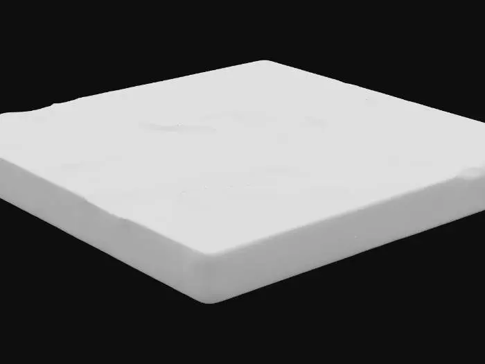 3D model for A substantial sandstone floor slab, measuring 2x2x0.1 meters, forms a broad, relatively thin planar surface. Its color is a warm, earthy ochre, typical of sandstone, with subtle variations in tone. The surface exhibits a slight camber, giving it a gentle, almost imperceptible curve. A fine layer of pale dust has settled unevenly across its gritty, coarse texture, making it feel dry and slightly abrasive to the touch, while the overall structure remains solid and unyielding.