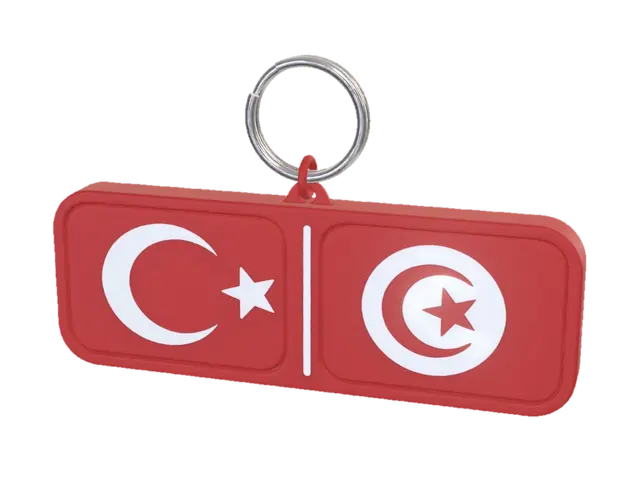 3D model for Create a realistic 3D printable keychain design. Rectangular horizontal shape with rounded corners. The front face contains the Turkish flag on the left and the Tunisian flag on the right, separated by a thin vertical line. Both flags are embossed (raised) for easy two-color 3D printing. Clean vector-style geometry, no textures, no shadows, no text, no background details. Designed specifically for FDM 3D printing with 2 mm raised elements and smooth edges. Keyring hole integrated on the left side. Symmetrical layout, professional souvenir keychain, CAD render, front view, white background.