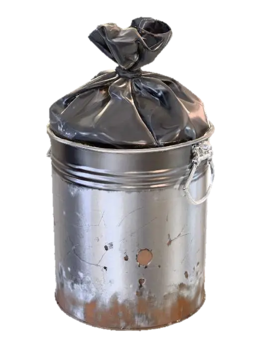 3D model for A small round metal trash bin, about 40cm tall. Surface slightly scratched, with faint dirt near the bottom. A half-full thin black garbage bag peeks from the top. Early 2000s cheap restroom accessory. Realistic PBR textures, simple geometry, game ready.

