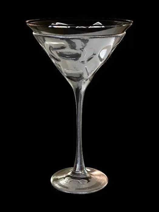 3D model for Ultra-realistic 3D product render of a tall elegant crystal martini glass with a thin stem and wide conical bowl, perfectly centered against a smooth light gray studio background. The martini glass is filled with large transparent ice cubes with realistic cracks, trapped air bubbles, frosty edges, and melting water droplets. Detailed condensation forms naturally on the outer surface of the glass, with tiny beads of water running down the sides. The glass material is highly realistic with accurate light refraction, caustics, reflections, and subtle imperfections in the crystal surface. Professional studio lighting setup with softbox reflections, cinematic highlights, soft shadows beneath the base, and depth realism. Hyper-detailed photorealistic CGI, Octane Render, Unreal Engine 5 quality,