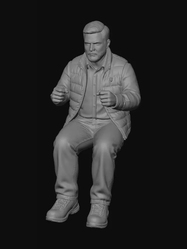 3D model for Create a 1/10 Scale realistic male figure. He would be in a sitting position, no base (invisible seat). His hands in a driving position, open hand, fingers slightly curled. His legs bent in a comfortable sitting position and 100 degrees. Knees slightly together. He is a around 40. He has brown hair, short cut, crew cut style, brushed to the right. He has a full beard. He is wearing a flannel shirt, with a puffer vest unzipped. He is wearing loose fit, carpenter style, denim jeans and hiking boots. Strong, medium sized hands, not too small.