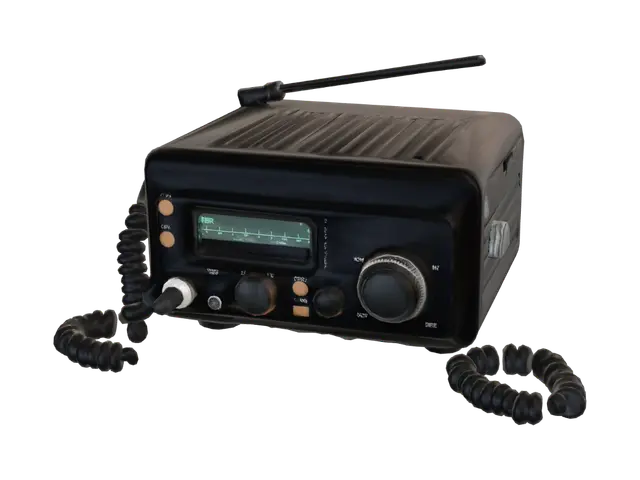 3D model for Game-ready low-poly rugged 1980s truck CB radio transceiver, compact rectangular dark brushed metal body, two amber knobs, small cyan signal display, coiled microphone mounted on the side, realistic worn industrial style, single self-contained object, clean silhouette, symmetrical front, no text, no logo, no brand, no background, optimized for a first-person driving game