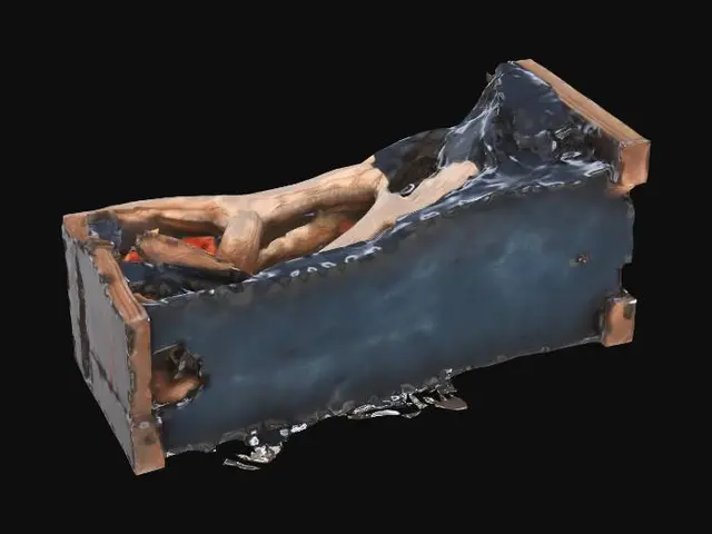 3D model for Burned and broken wooden furniture lies on its side, deeply charred and blackened from a fire. It is rendered with clean, angular geometry.
